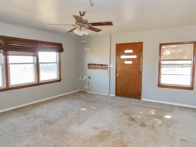 carpeted entrance foyer with ceiling fan and plenty of natural light