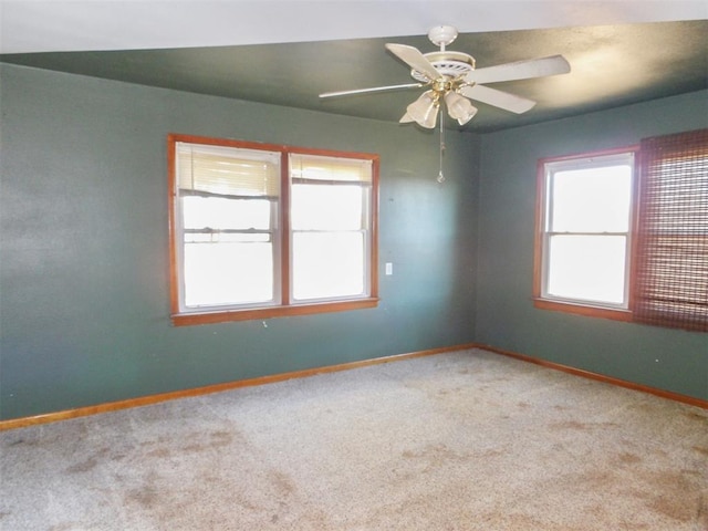 carpeted empty room featuring ceiling fan