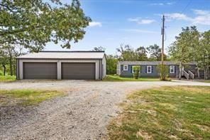 view of front of home with an outbuilding and a garage