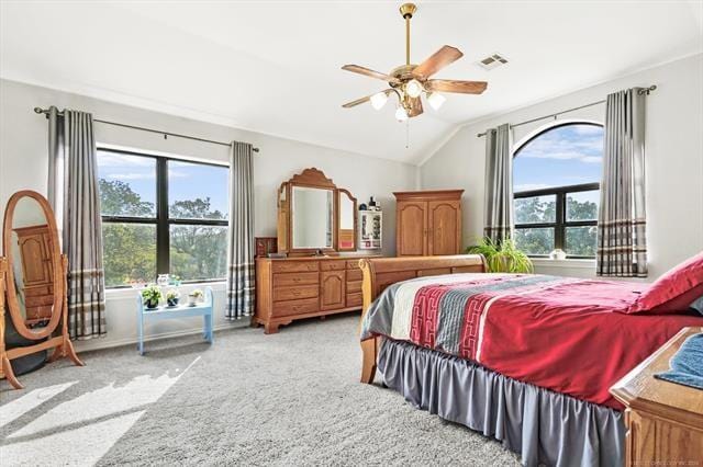 carpeted bedroom with multiple windows, lofted ceiling, and ceiling fan