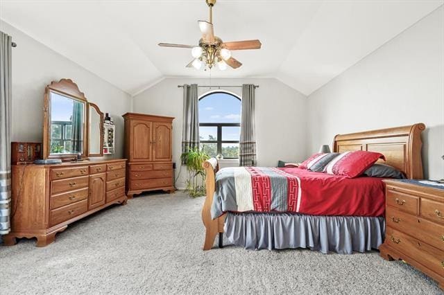 bedroom featuring multiple windows, ceiling fan, light colored carpet, and vaulted ceiling