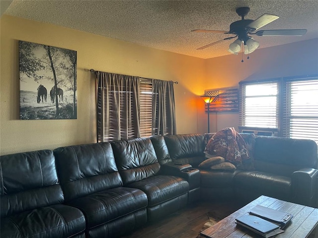 living room featuring ceiling fan, wood-type flooring, and a textured ceiling