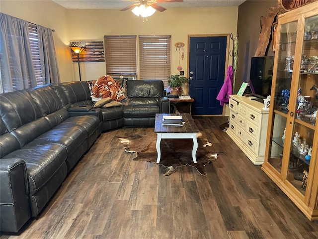 living room featuring ceiling fan, dark hardwood / wood-style flooring, and a textured ceiling