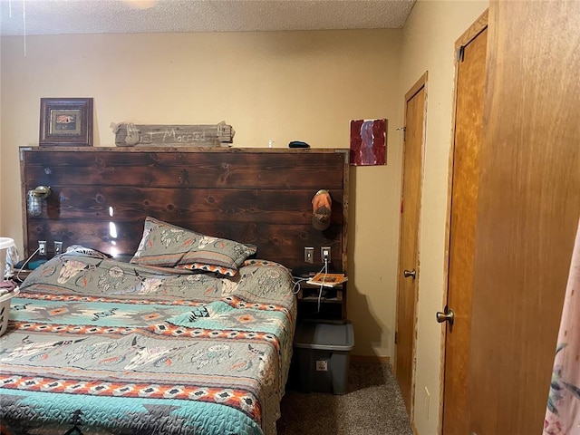 carpeted bedroom featuring a textured ceiling