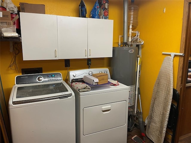 laundry area featuring separate washer and dryer, water heater, and cabinets