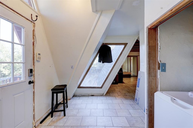 foyer entrance with a wealth of natural light and washer / dryer