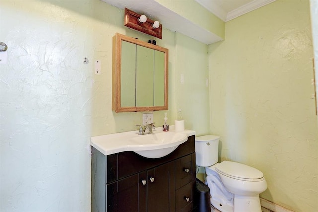 bathroom featuring vanity, toilet, and crown molding