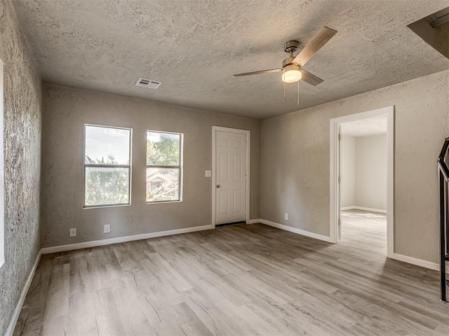 spare room with ceiling fan and light hardwood / wood-style flooring