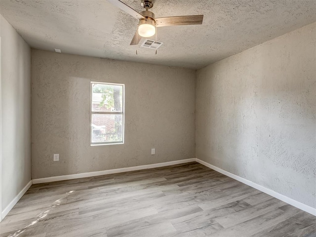 spare room with ceiling fan and light hardwood / wood-style floors