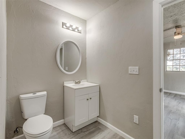 bathroom with hardwood / wood-style flooring, vanity, and toilet