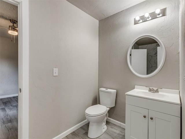 bathroom with hardwood / wood-style flooring, vanity, and toilet