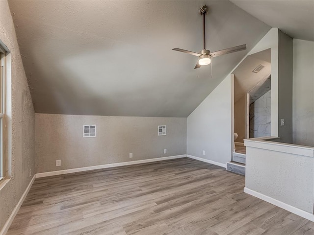 bonus room featuring ceiling fan, light hardwood / wood-style floors, and vaulted ceiling