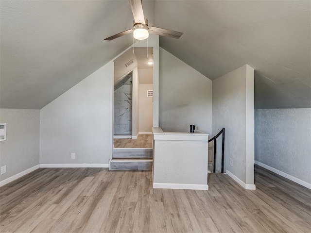 bonus room with ceiling fan, light hardwood / wood-style floors, and lofted ceiling