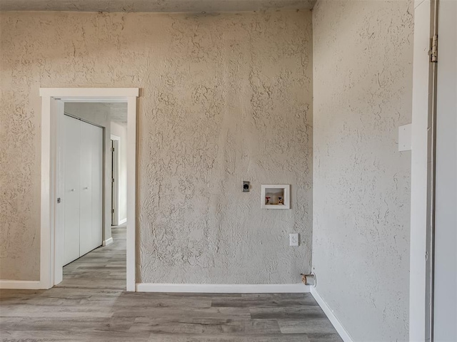 laundry room with hookup for an electric dryer, hookup for a washing machine, and hardwood / wood-style flooring