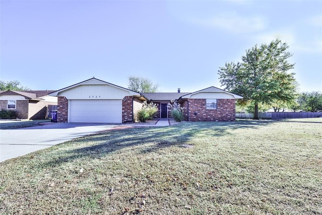 ranch-style home featuring a garage and a front lawn