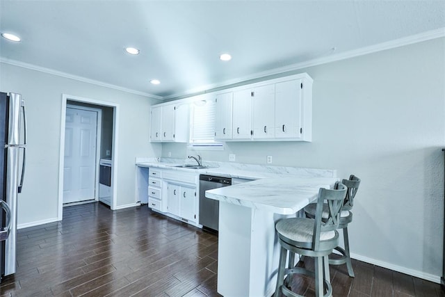 kitchen with white cabinets, appliances with stainless steel finishes, dark hardwood / wood-style floors, and sink