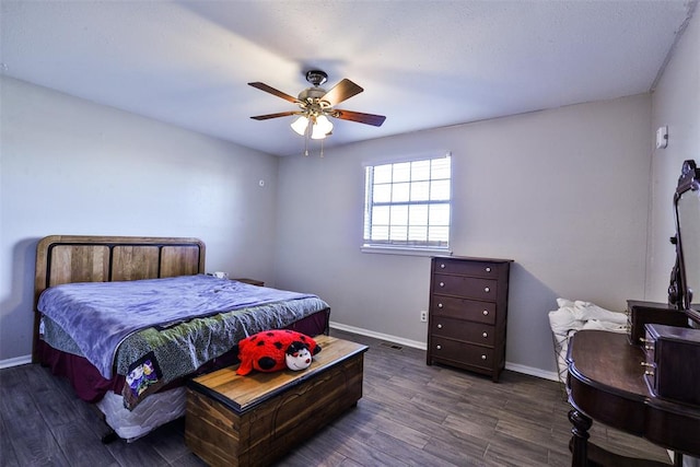 bedroom with ceiling fan and dark wood-type flooring