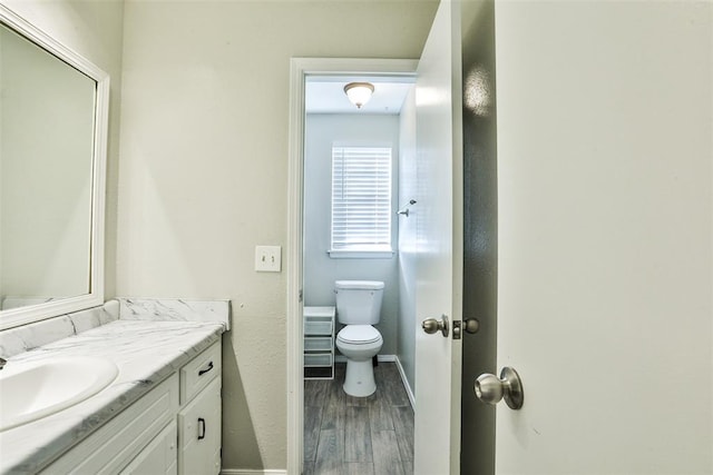 bathroom featuring hardwood / wood-style flooring, vanity, and toilet