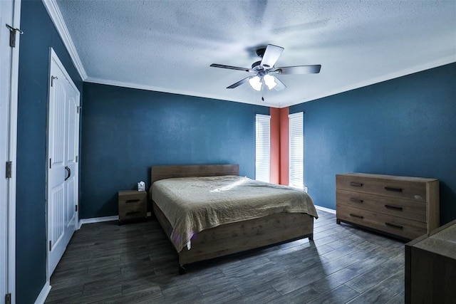 bedroom with a textured ceiling, ceiling fan, crown molding, and dark wood-type flooring