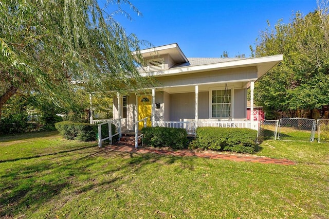 view of front of home with a front yard and a porch