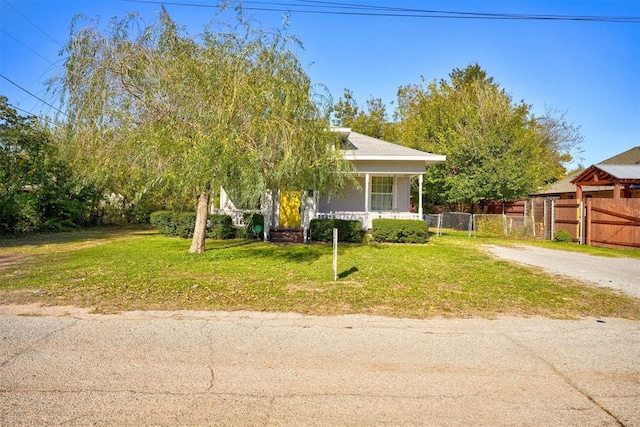 obstructed view of property featuring covered porch and a front yard