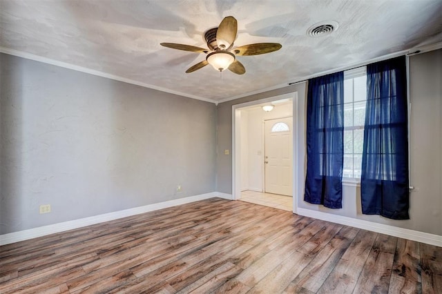 entryway with ceiling fan, wood-type flooring, and ornamental molding