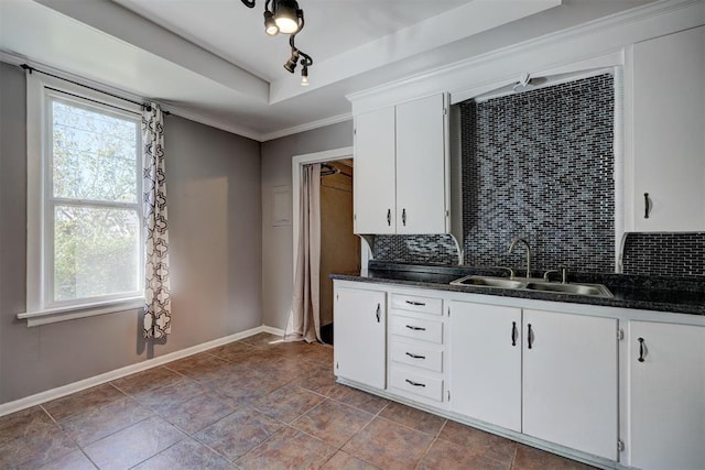 kitchen with white cabinets, sink, ornamental molding, tasteful backsplash, and light tile patterned flooring