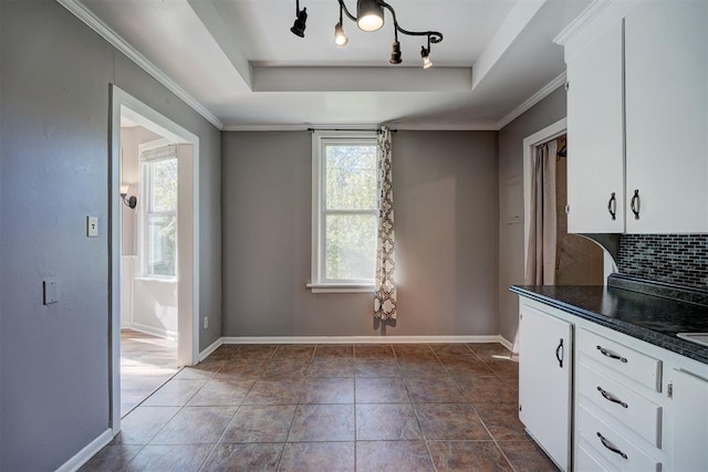 interior space featuring ornamental molding and a tray ceiling