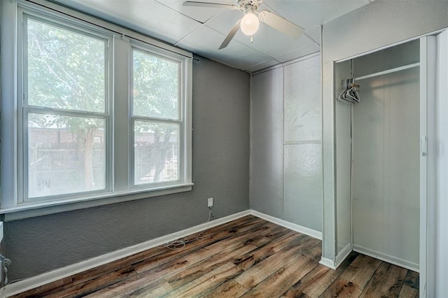 spare room featuring wood-type flooring and ceiling fan