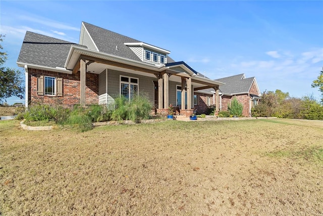 view of front of property featuring a front yard and covered porch