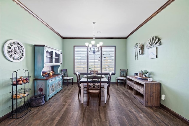 dining space with ornamental molding, dark wood-type flooring, and an inviting chandelier