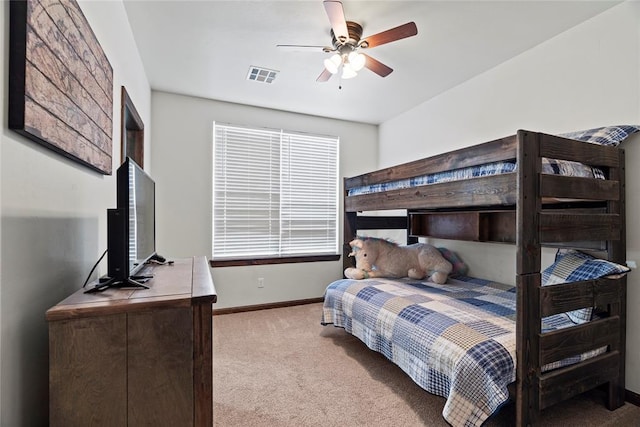 bedroom with ceiling fan and light carpet