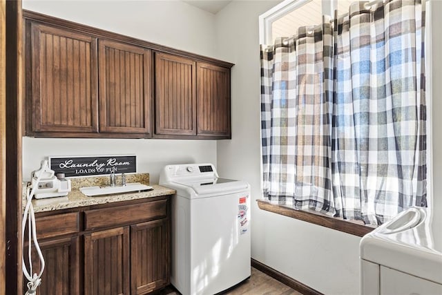 washroom with sink, light wood-type flooring, and washer / dryer