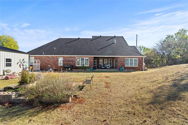 back of house with a yard and a patio