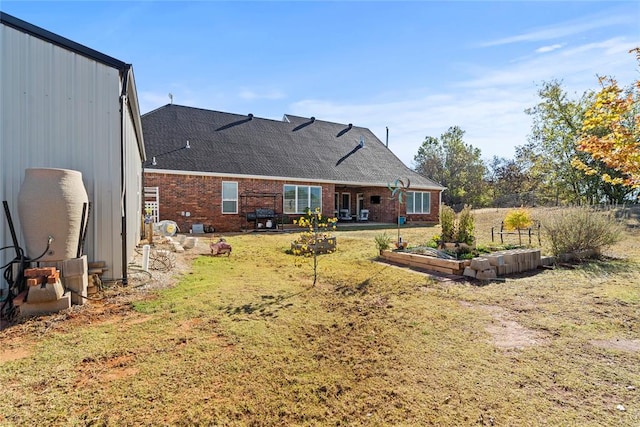 rear view of house featuring a lawn