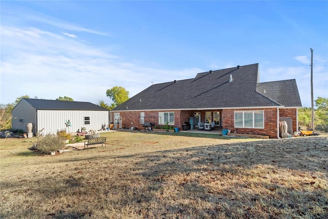 back of house featuring a patio and a lawn