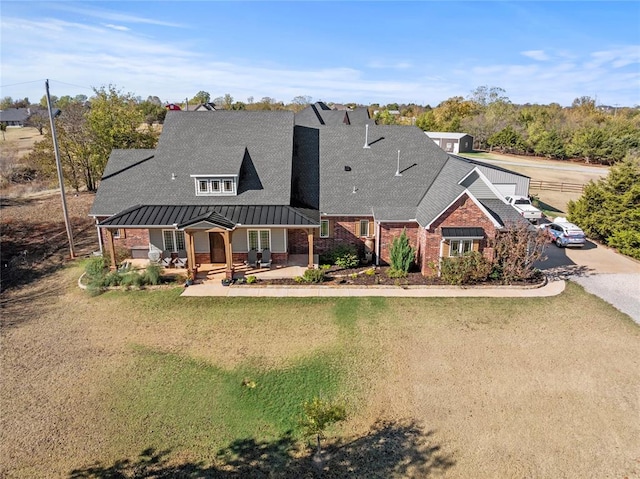 view of front of property with a patio area and a front yard