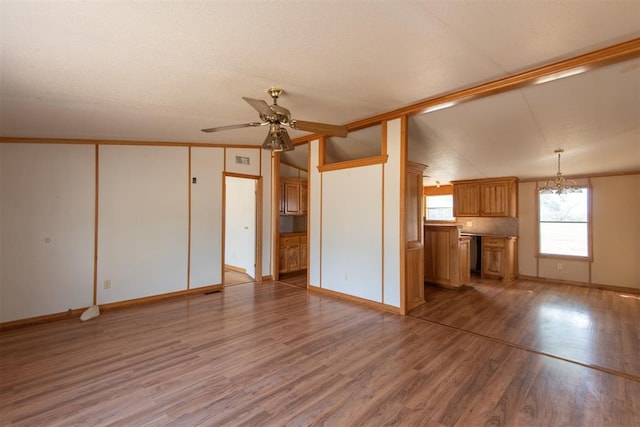 unfurnished living room featuring a textured ceiling, ceiling fan, hardwood / wood-style floors, and lofted ceiling