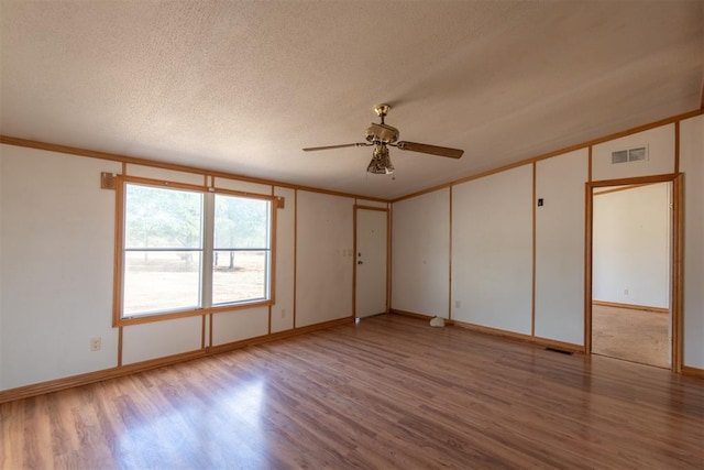 spare room featuring ceiling fan, light hardwood / wood-style flooring, crown molding, and a textured ceiling