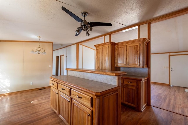 kitchen featuring hardwood / wood-style flooring, a kitchen island, and a textured ceiling