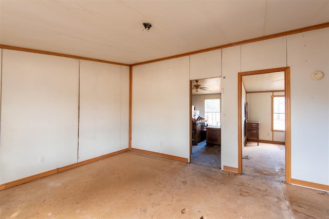 empty room with ceiling fan and ornamental molding