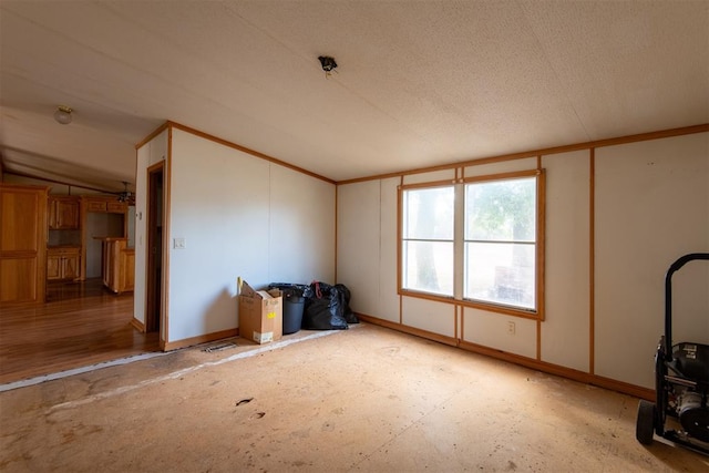 misc room with a textured ceiling and vaulted ceiling