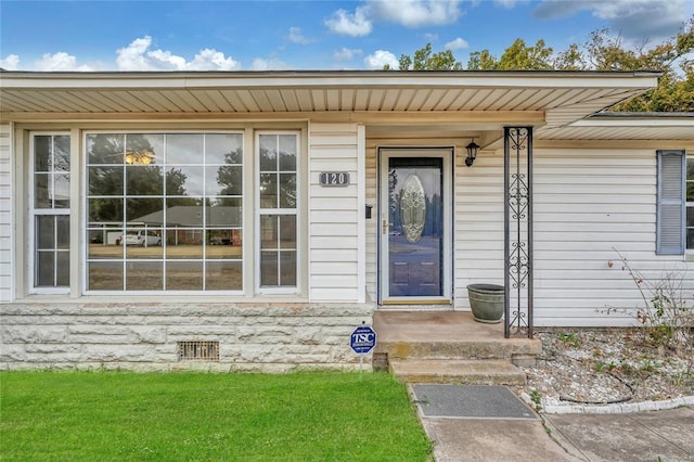 entrance to property with a yard