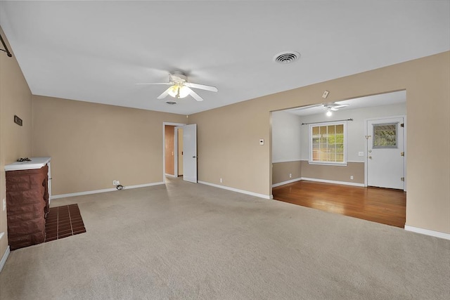 unfurnished living room with light carpet and ceiling fan