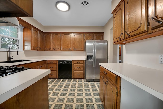 kitchen with gas stovetop, dishwasher, stainless steel refrigerator with ice dispenser, and sink