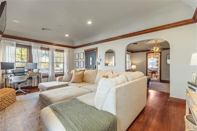 living area with baseboards, visible vents, arched walkways, dark wood finished floors, and crown molding