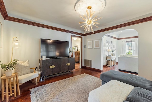 living room with crown molding, dark hardwood / wood-style flooring, and a notable chandelier