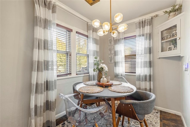 dining area with ornamental molding and a notable chandelier