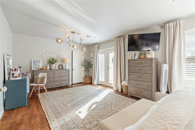 bedroom with dark wood-style floors, access to outside, french doors, and visible vents