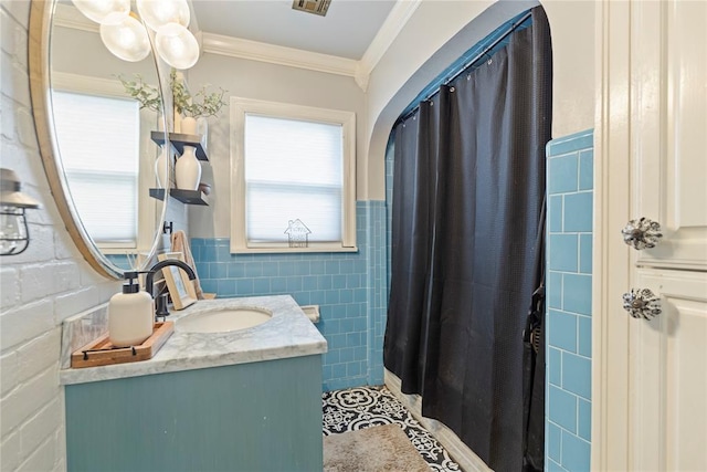 bathroom with crown molding, tile walls, and vanity